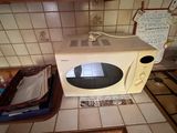 un micro-ondes posé sur le plan de travail de la cuisine