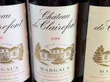 three bottles of wine are lined up on a table