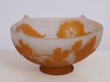an orange and white bowl sitting on top of a table