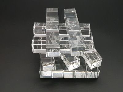a stack of clear plastic boxes on a black surface