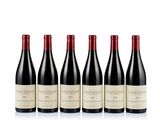 four bottles of wine are lined up on a white surface