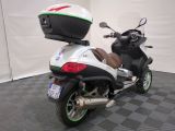 a scooter with a helmet on the back of it