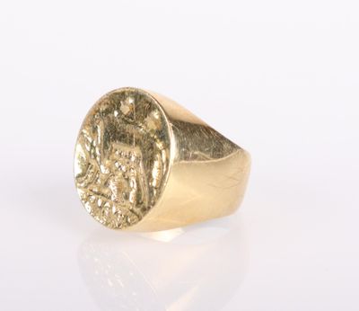a close up of a gold ring with a coin on it