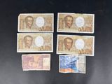 six different bills of different colors and shapes on a black surface