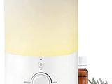 a white humider with lavender flowers next to it and a bottle of essential oils