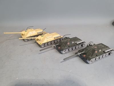 several toy tanks are lined up in a row on a table