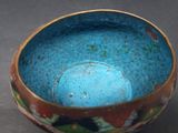 a blue bowl with flowers on it on a table