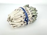 a white vase with a bunch of asparagus on it