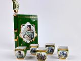 five cups and a book with a picture of a soldier on them