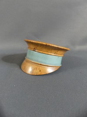a small wooden bowl on a table with a blue ribbon around it