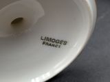 a close up of a white vase with a label on it