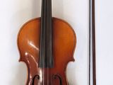 a violin that is sitting next to a bow