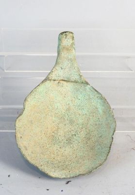a green vase that is sitting on a table