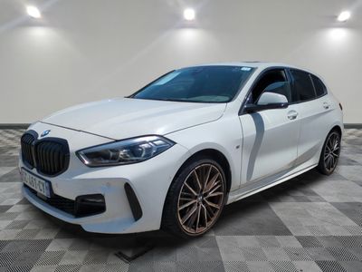 a white bmw x2 parked on a checkered floor