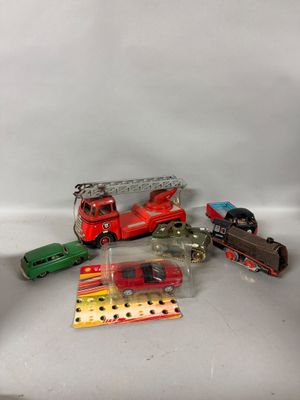 a lot of toy cars and a train on a table