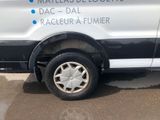 a white van parked in front of a building
