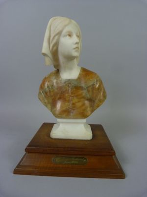 marble bust of a woman with a turban on a wooden base