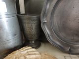 a loaf of bread sitting on a counter next to a silver cup