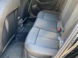 the back seats of a car are empty in a parking lot