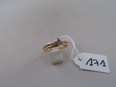 a gold ring with a diamond on it and a price tag