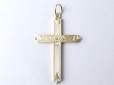 a close up of a gold cross on a white surface