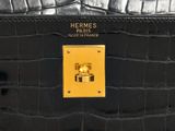 black and gold leather purse with a gold button on it