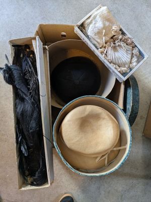 a box full of hats and other items on the floor