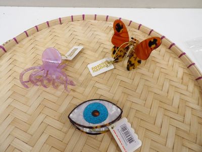 a table with a plate with a butterfly and a blue eye on it