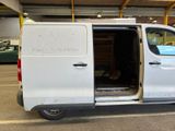 a white van parked in a parking lot with its doors open