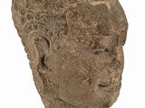 an image of a stone head on a stand on a white surface