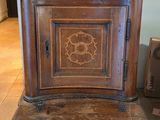 a small wooden cabinet with a decorative design on it