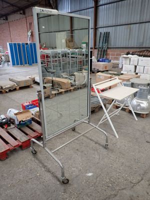 a large mirror that is sitting in the middle of a warehouse