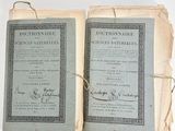 pair of old french dictionary books sitting on top of each other