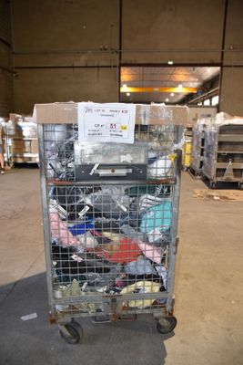 a metal cart with many items in it in a warehouse