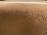 a close up of a tan leather purse with a zipper