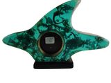 green and white marble sculpture of a starfish on a black base