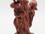 chinese carved figurine of a man carrying a bag