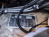 a close up of a car ' s engine with wires on it