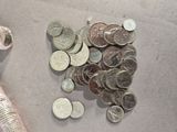 a lot of coins and a measuring spoon on the table