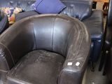 two leather chairs and a couch in a room