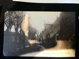 a black and white photo of a street with trees