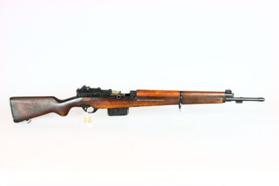 an old rifle with a wooden barrel on a white background