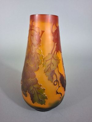 a vase with a design on it sitting on a table
