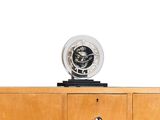 a clock that is on top of a wooden cabinet