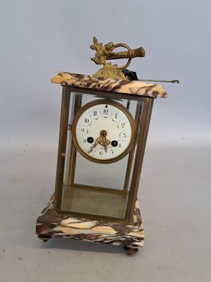 a small clock with a bird on top of it
