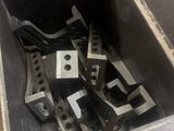 many pieces of metal in a metal box on the floor