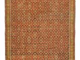 un tapis orange et vert orné d'un motif en médaillon