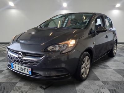the grey opel is parked in a large room with checkered floor