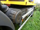 a large yellow truck that is parked on the side of the road