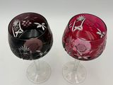 two wine glasses sitting next to each other on a table